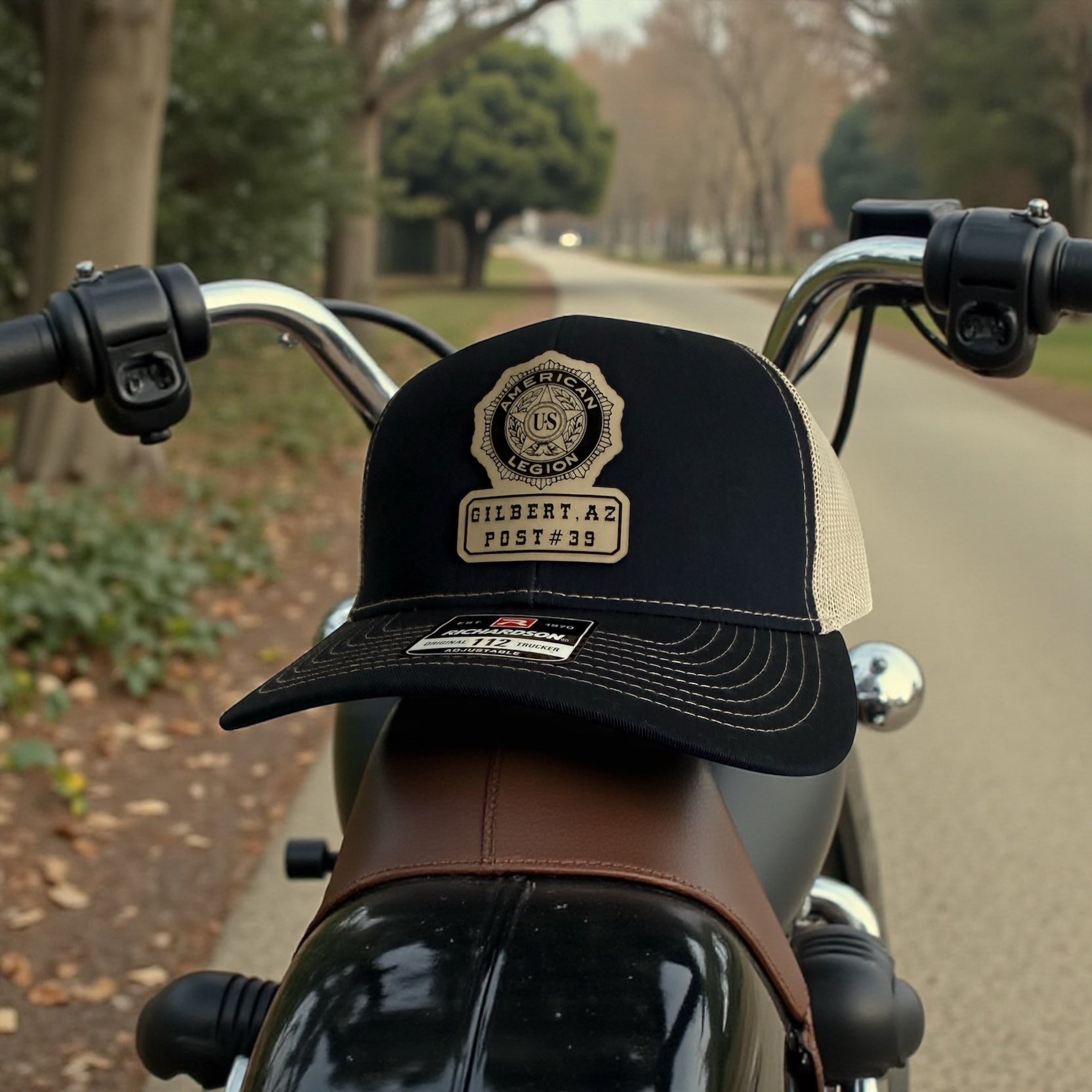 Black cap with engraved leather patch  on a motorcycle handlebar